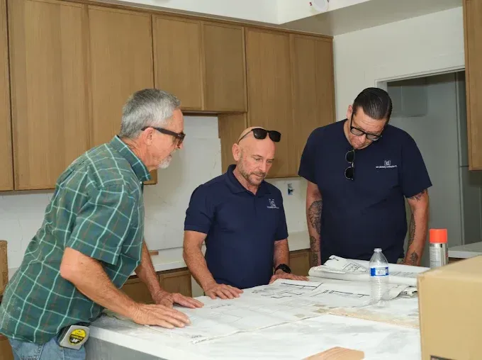 KCB Plumbing team reviewing plans for a new-build project in Orange